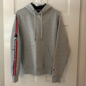Men’s gray hoodie sweatshirt with logo running down arm.